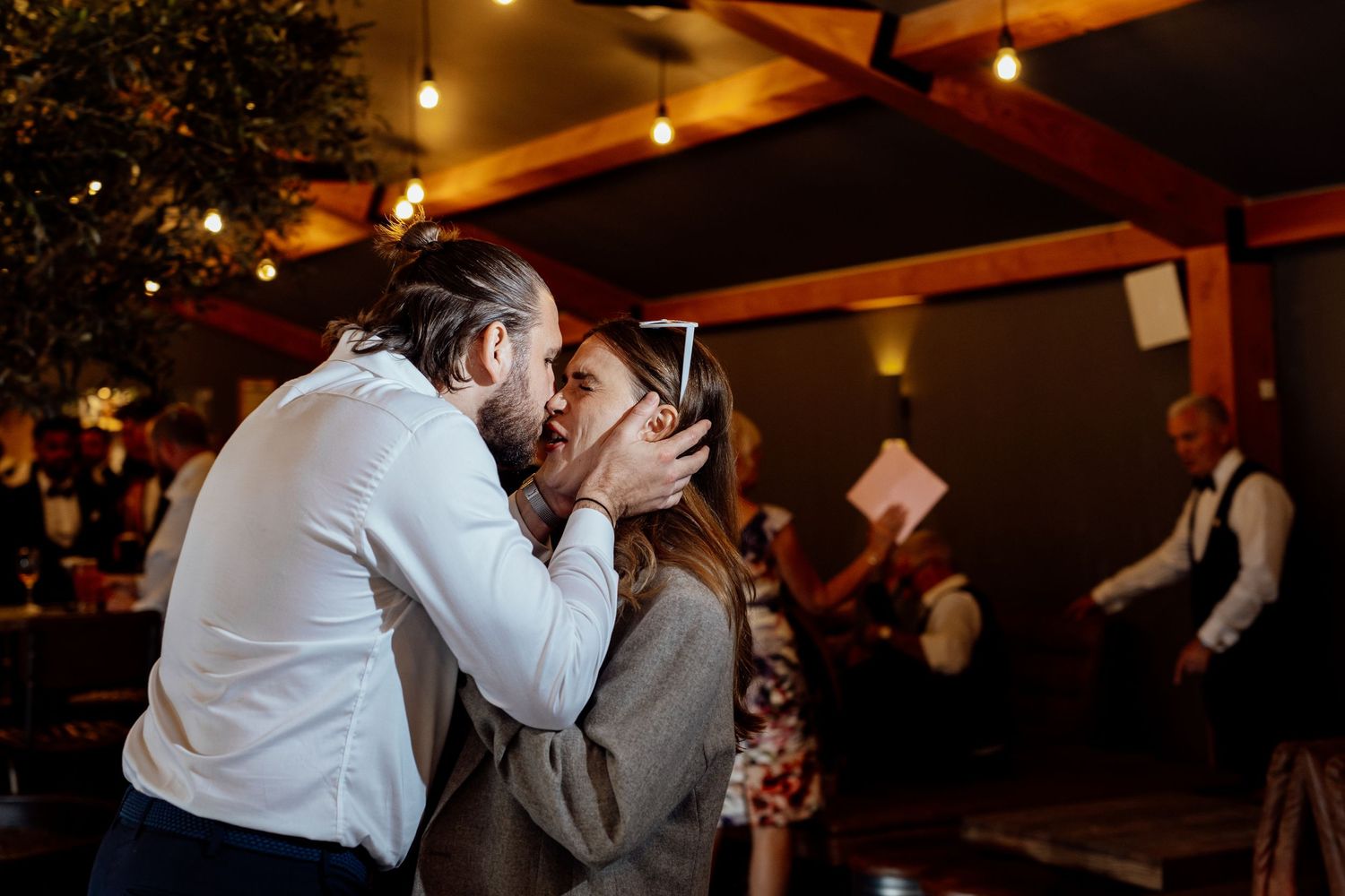 Romantic evening reception with warm lighting and dancing couples.