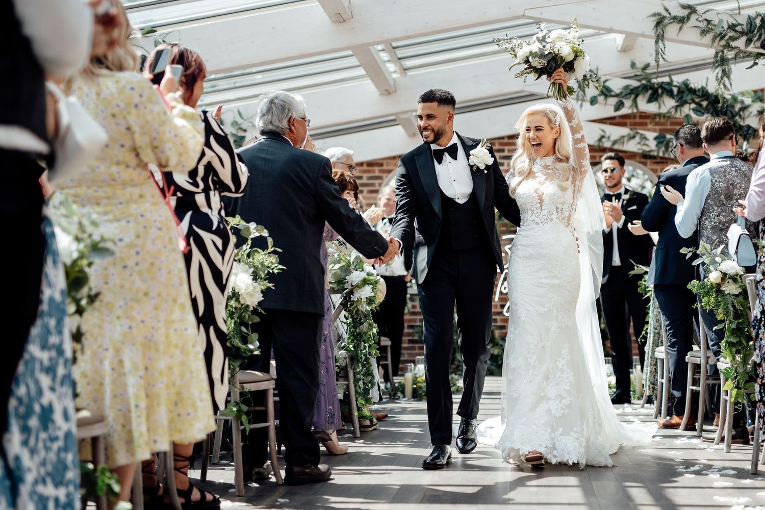 Wedding guests line up for a celebratory reception entrance.