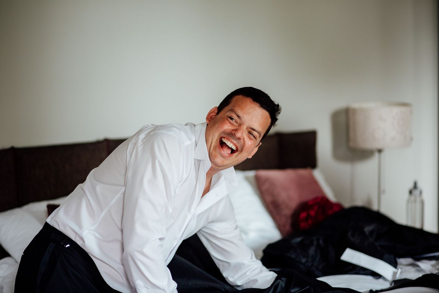 Candid moments captured during wedding day preparations in a bright room.