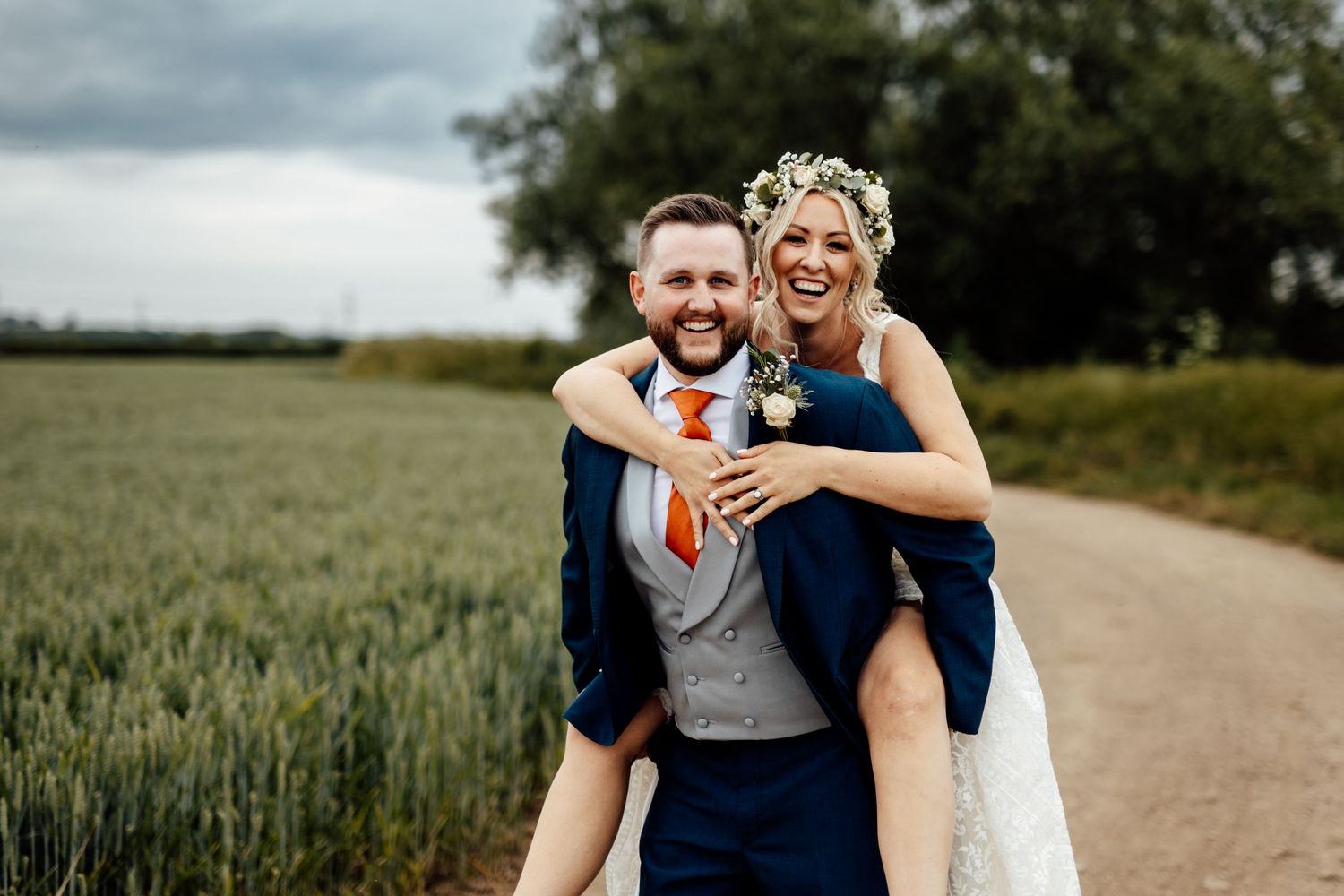 Playful moment captured on rural path with fields in background.