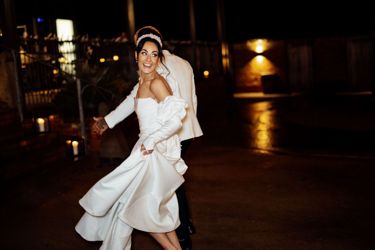 Wedding couple dancing and celebrating during their evening reception.