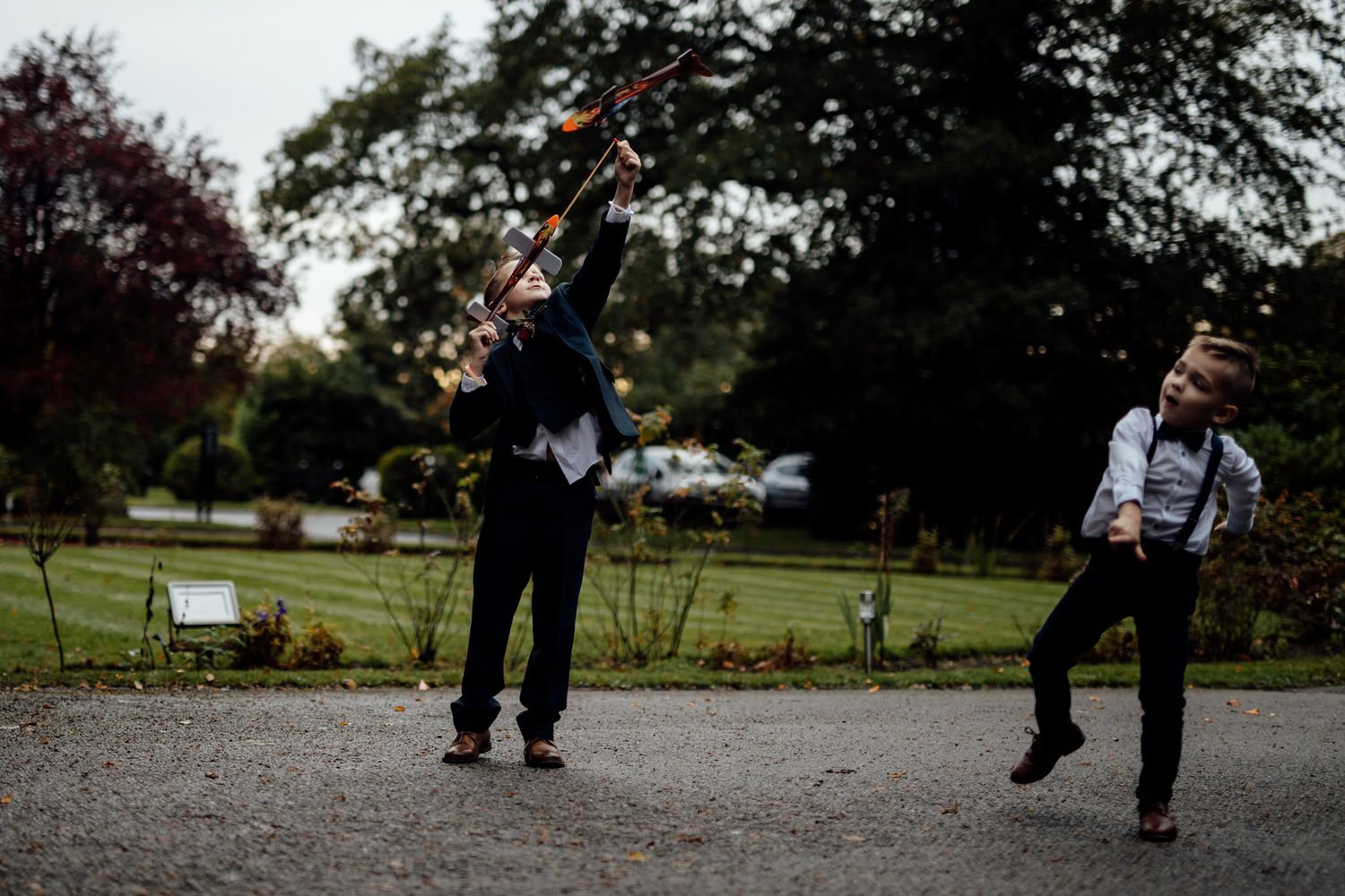 People playing on swings in a park during an outdoor event.