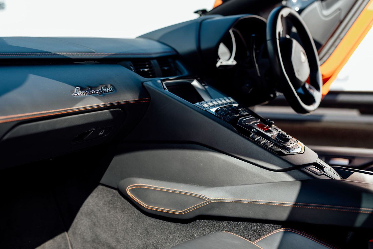 Interior detail shot of a luxury car dashboard and control panel.