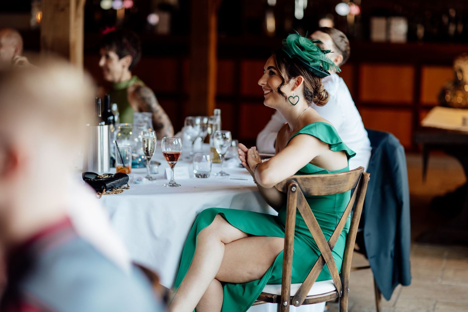 Reception guests in formal attire seated at dining tables during the celebration.