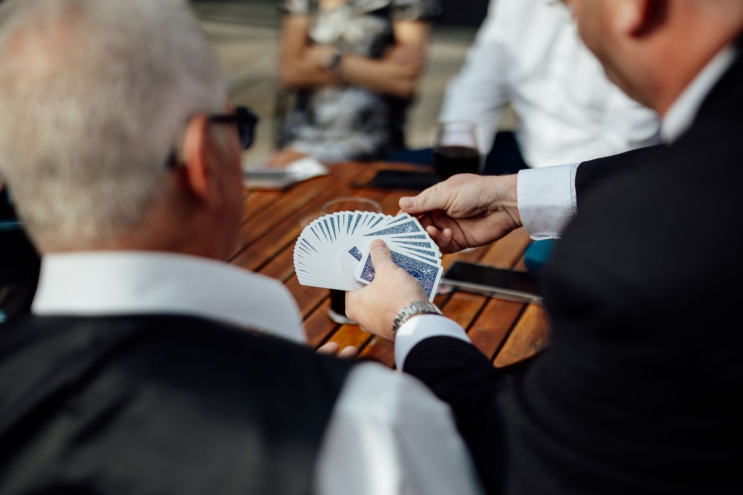 Close-up shot of hands exchanging wedding rings during ceremony.