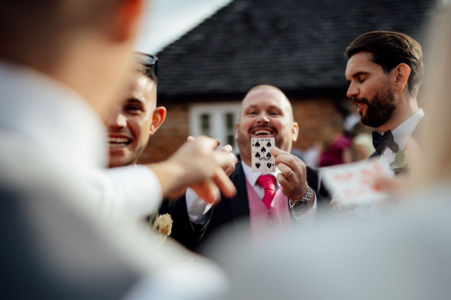 Wedding guests share joyful moments during outdoor reception celebrations.