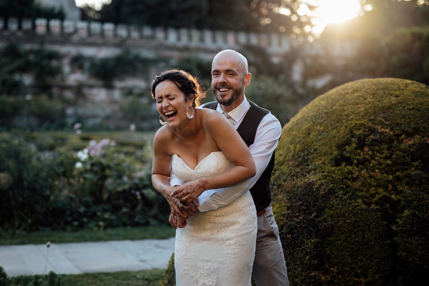 Romantic sunset portraits of newlyweds in a garden setting.