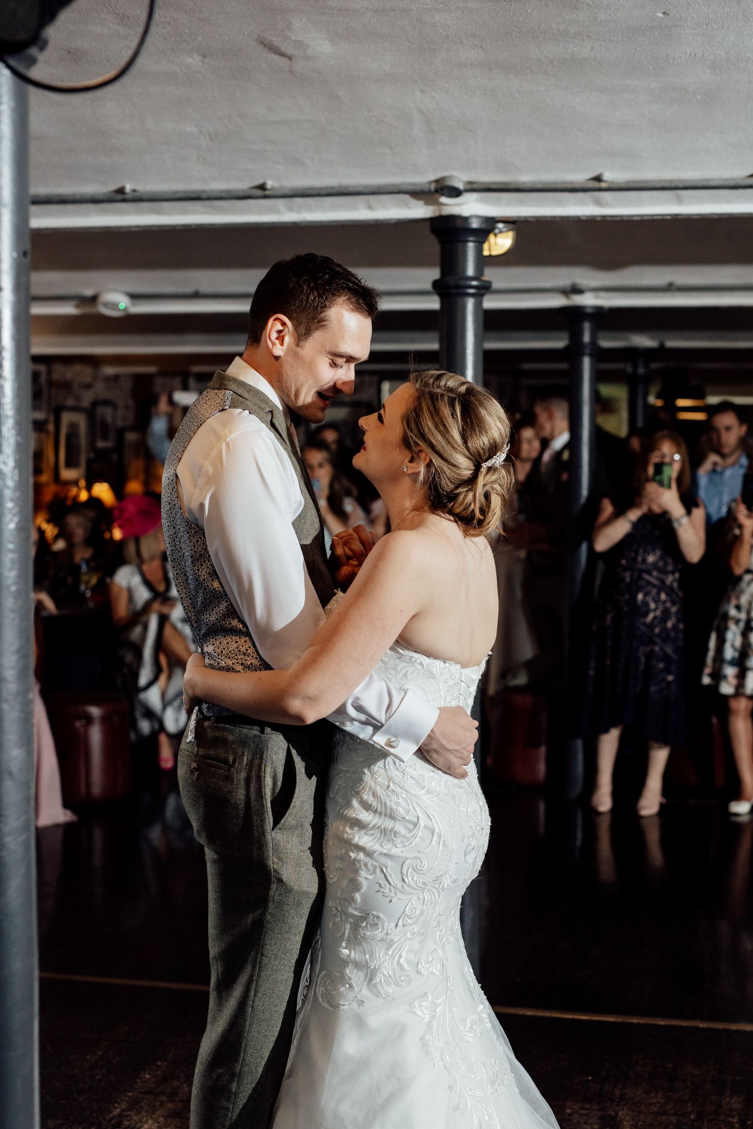 Couples dancing together at an indoor wedding reception.