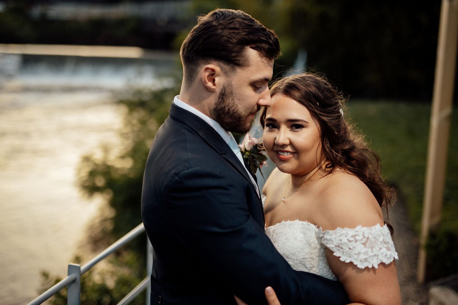 Intimate wedding portraits captured against a natural outdoor backdrop at sunset.