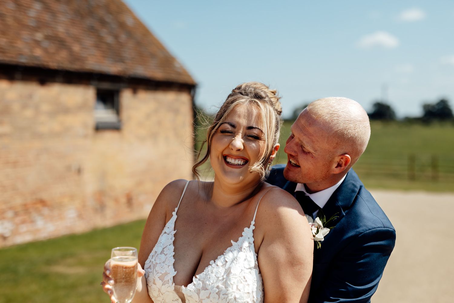Candid wedding moments captured outdoors at rustic countryside venue.