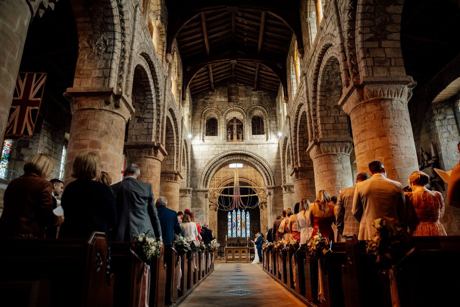 Interior of a historic church with vaulted ceilings and dramatic lighting.