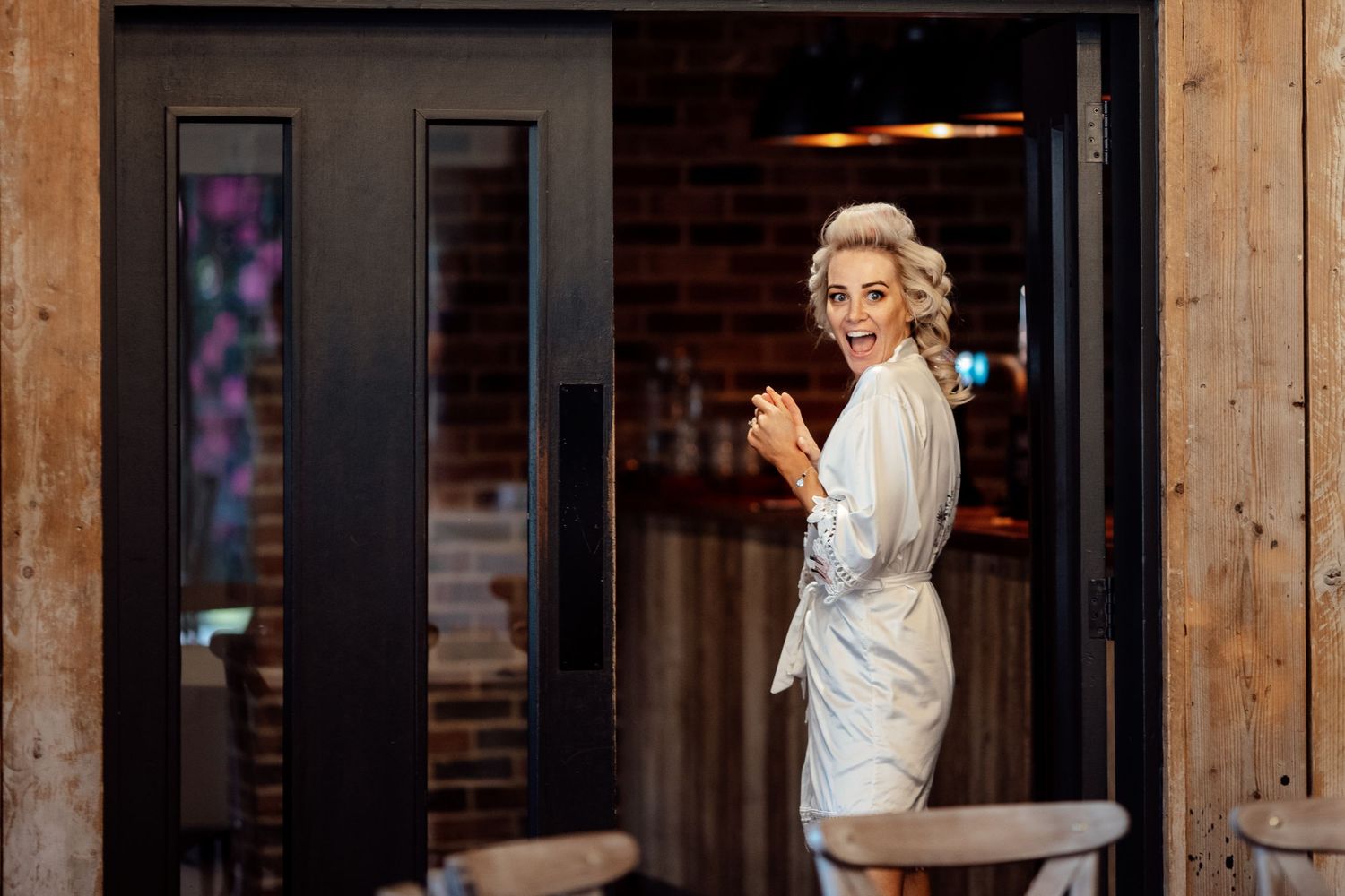 Rustic wooden beams and brick walls create an industrial chic wedding venue atmosphere.