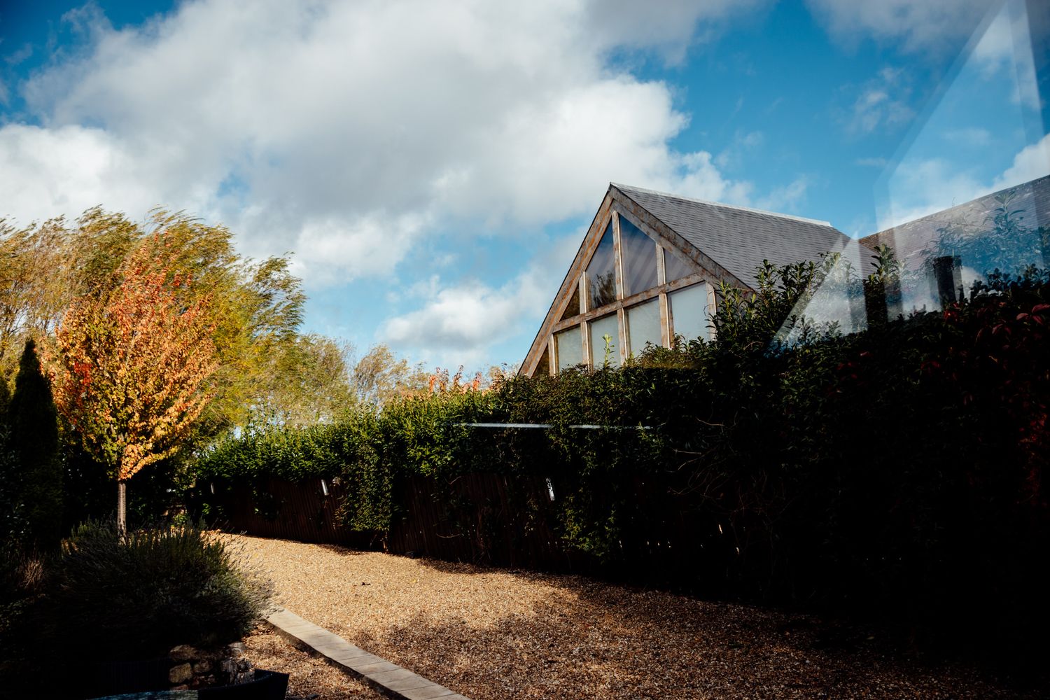 Panoramic view of a countryside wedding venue with cloudy sky and fall foliage.