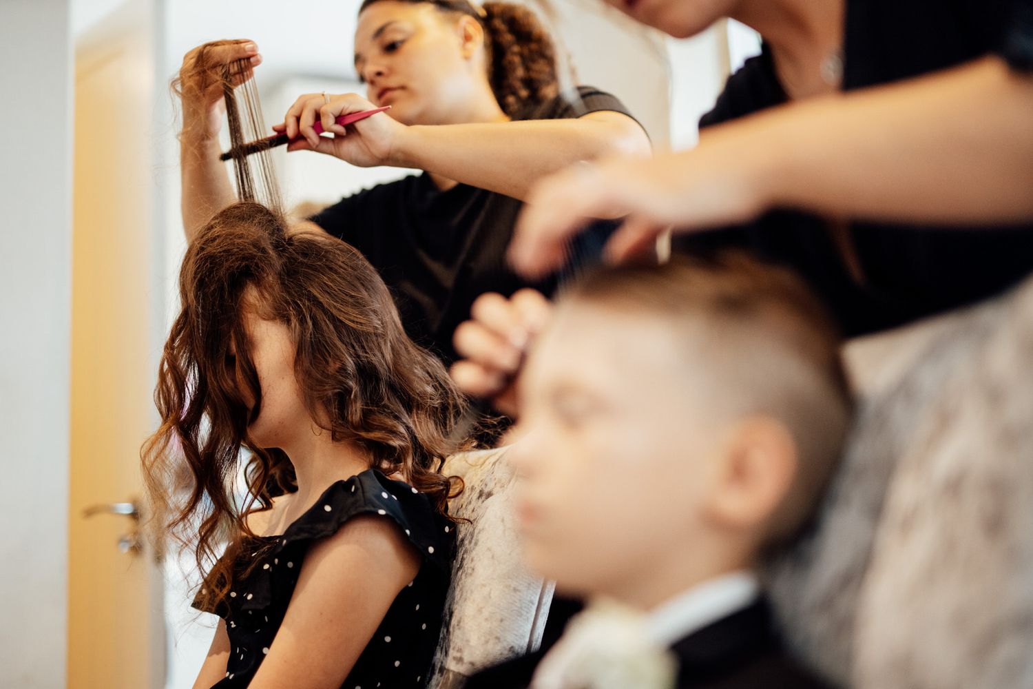 Wedding preparations with elegant dress and hair styling in soft natural light.