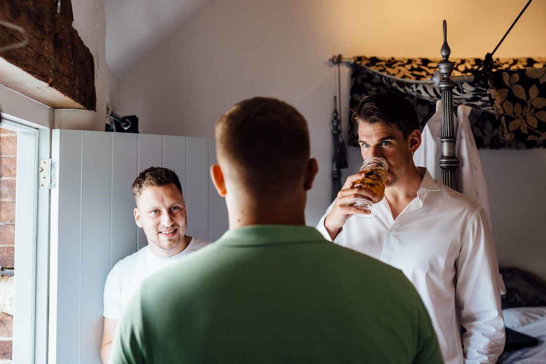 People mingle in a bright indoor space during a wedding celebration.