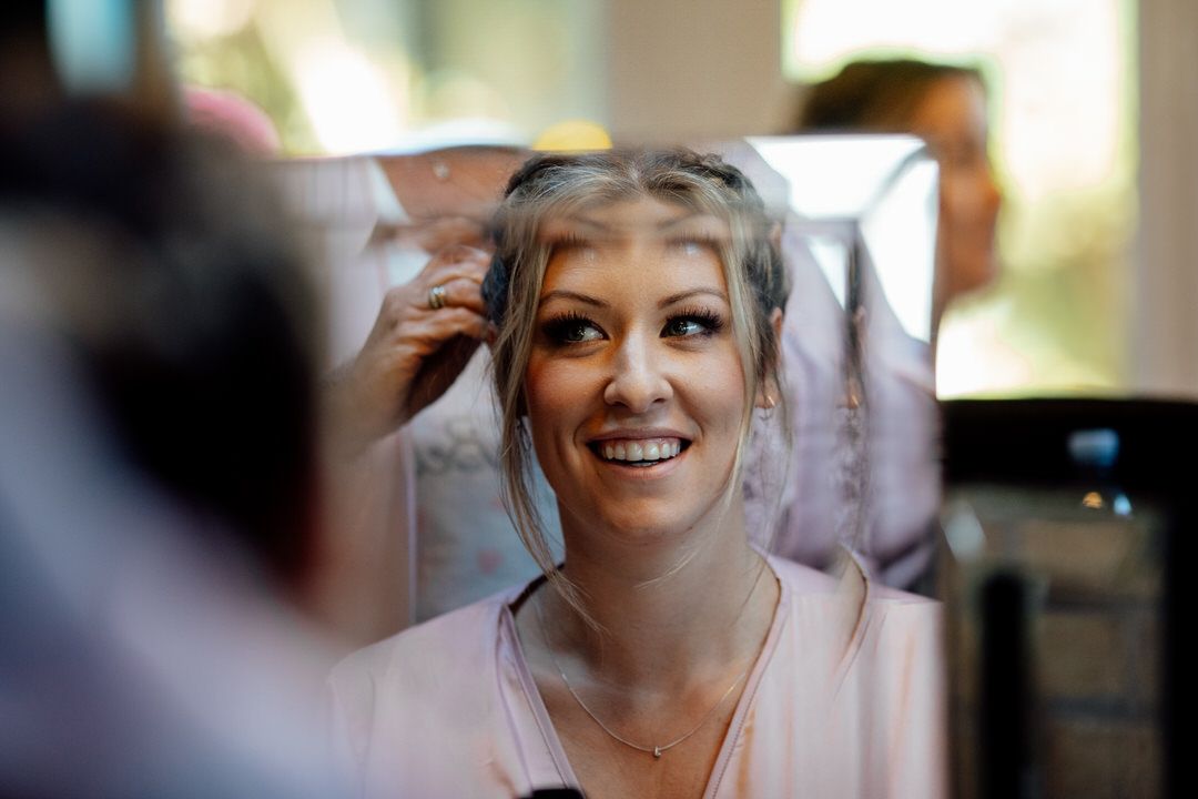 Natural light portraits during wedding preparations with soft window lighting.
