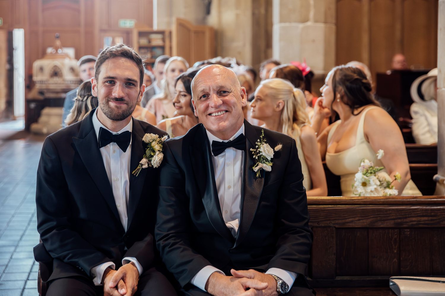 Wedding guests celebrate during indoor reception in elegant church setting.