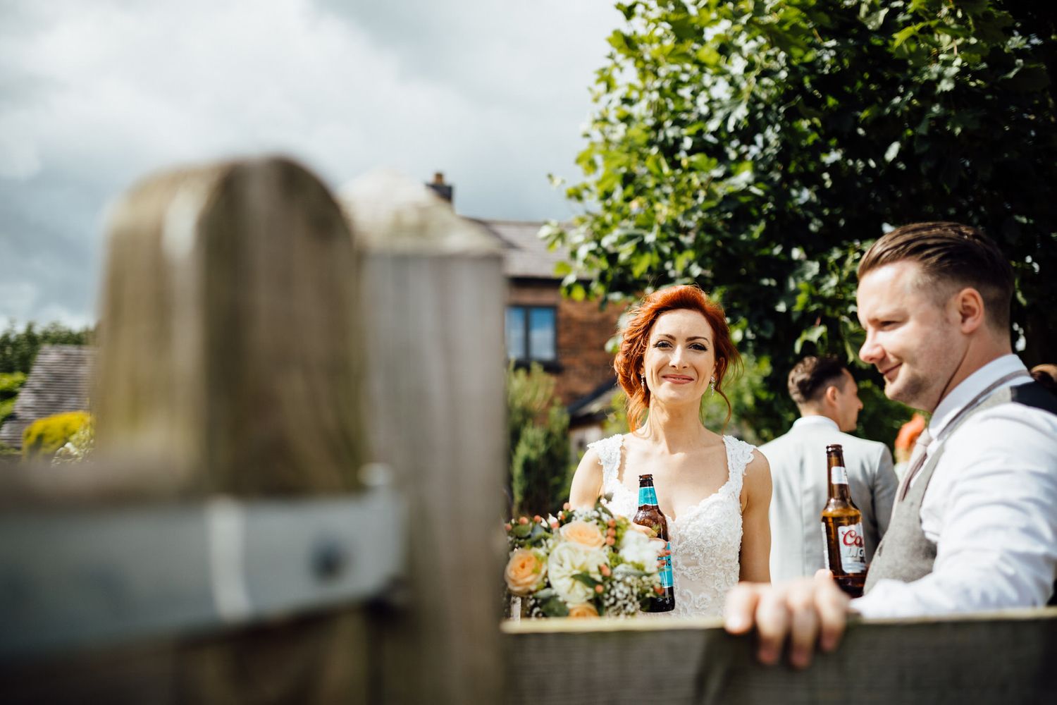 Wedding guests enjoying drinks and conversation at an outdoor reception.