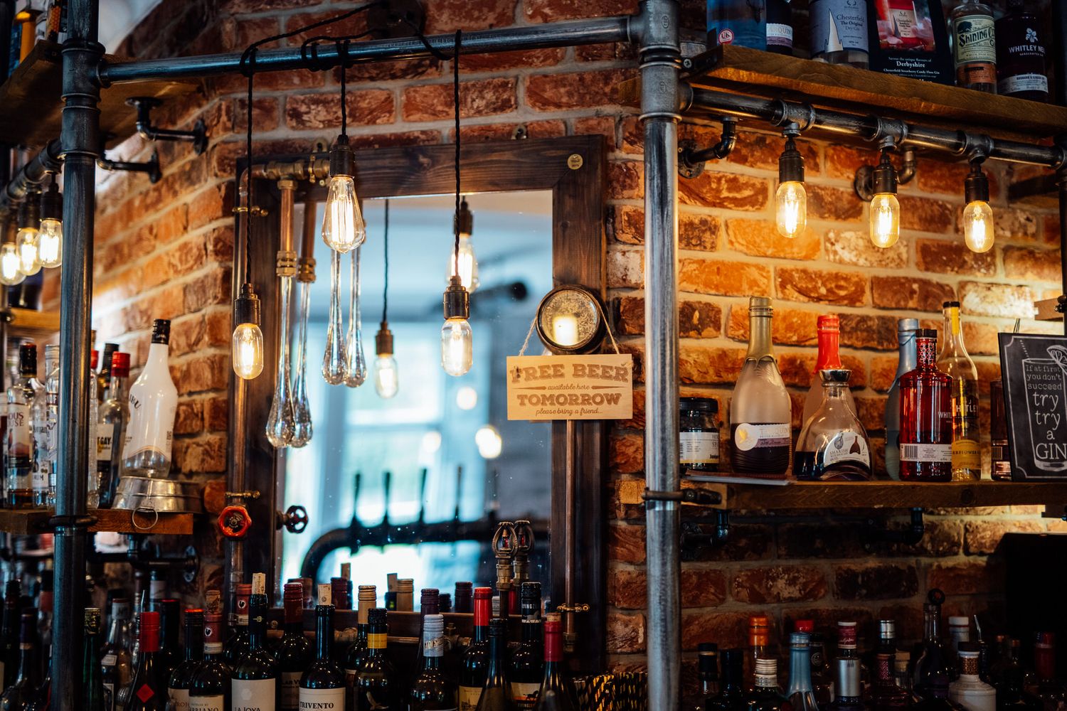 Rustic bar interior with exposed brick walls and vintage lighting fixtures.