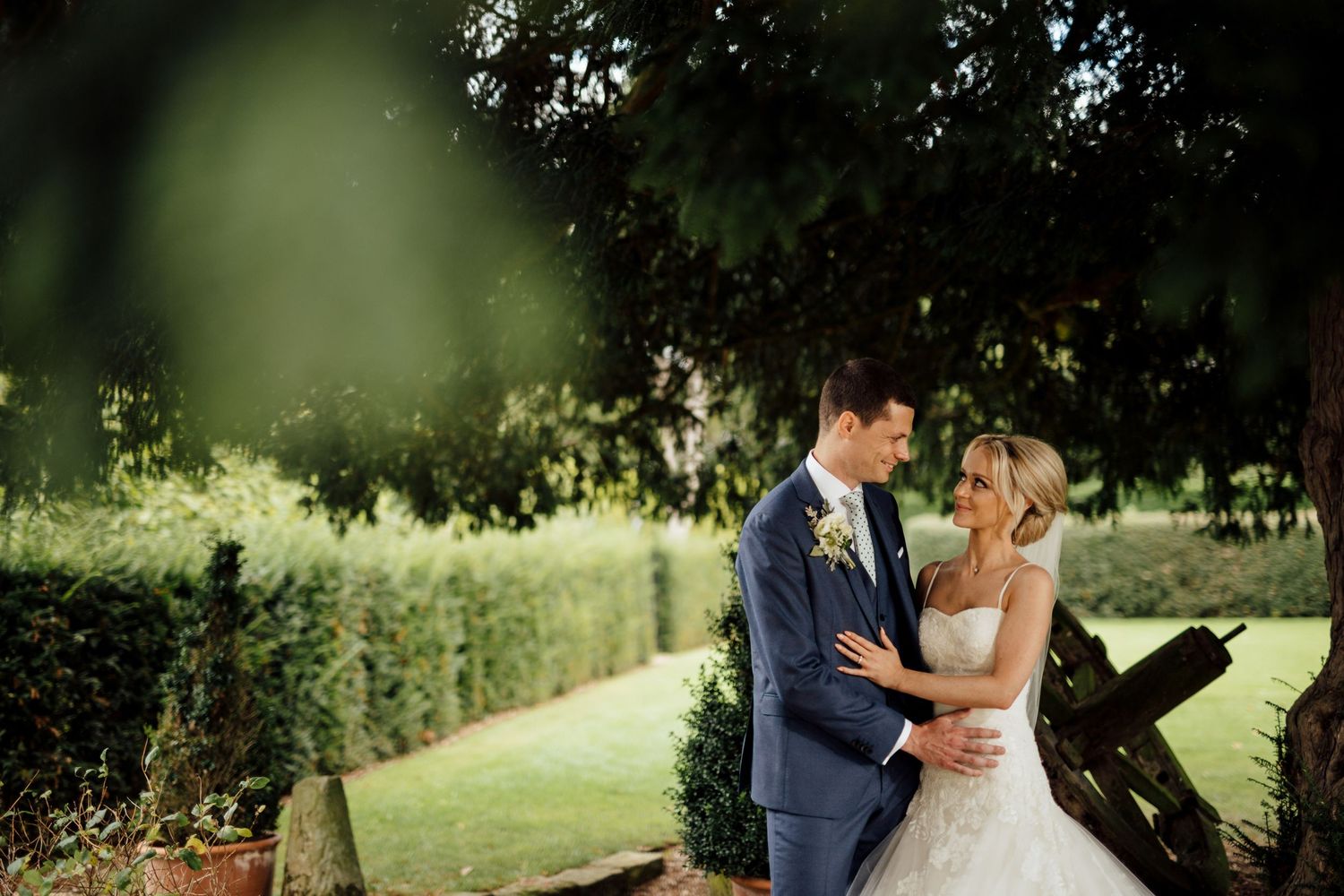 Romantic wedding portraits taken in a lush garden setting.