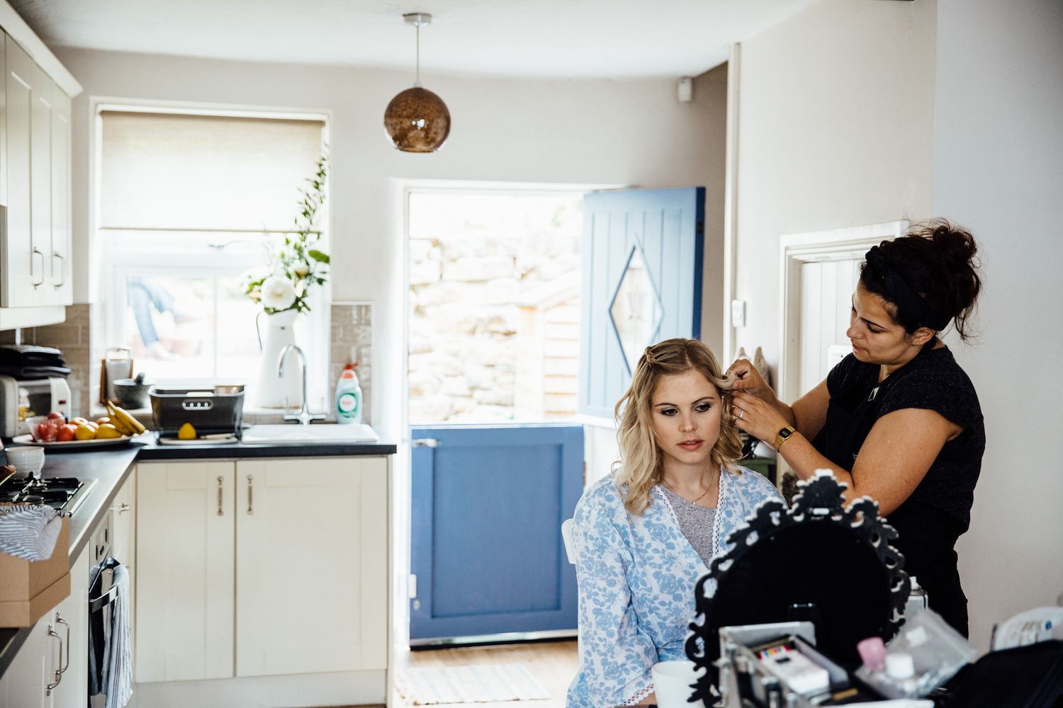 Wedding preparation scene in a bright modern room with natural lighting.