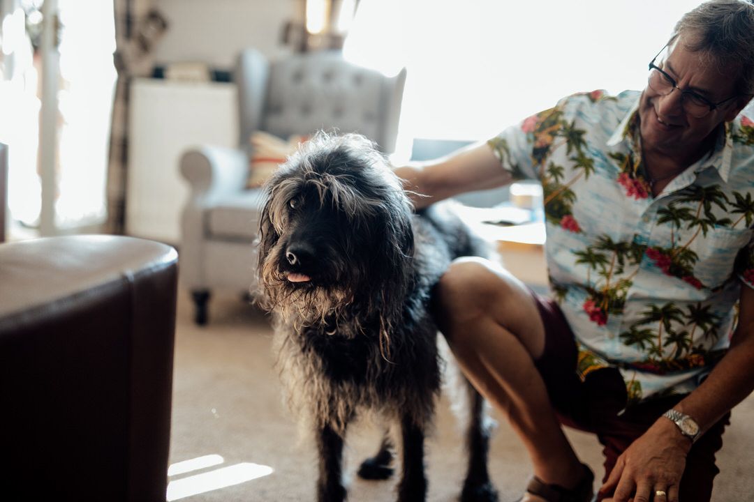 Candid moments of wedding preparation in natural window light.