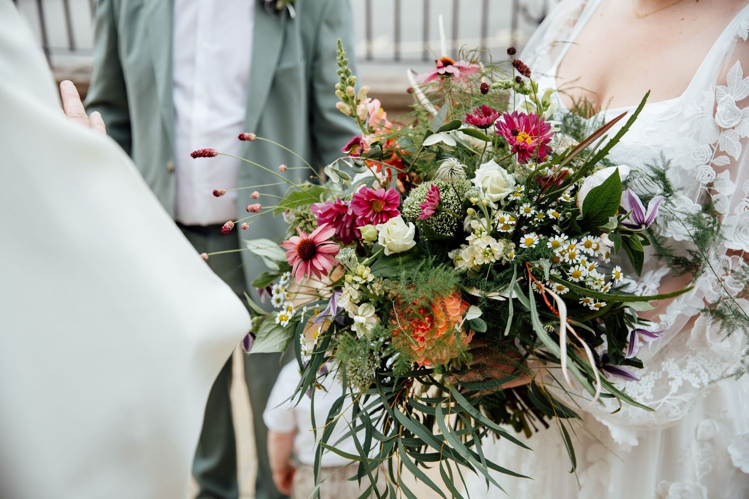 Colorful wedding bouquets with pink and white flowers arranged on a table.