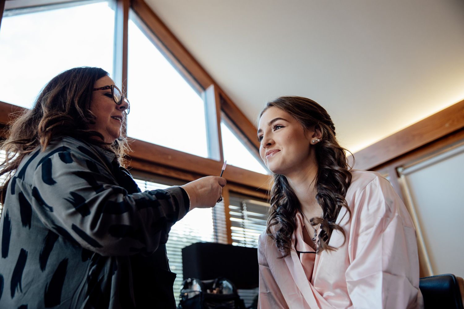 Morning wedding preparation scene in a bright, window-lit room.