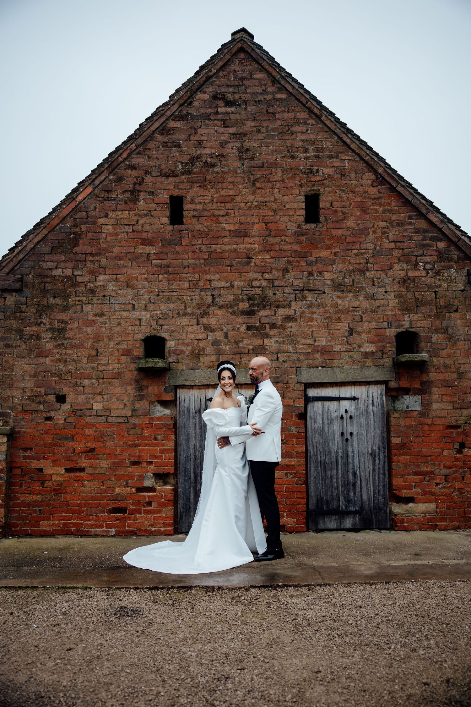 A sequence of wedding photos against rustic brick barn walls showing romantic moments in natural light.