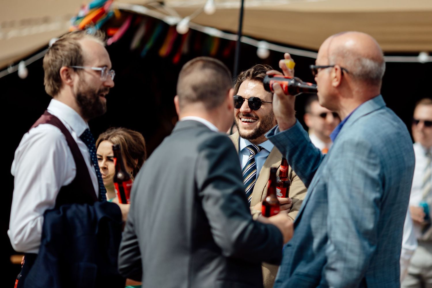 Guests mingling and socializing during an outdoor wedding reception.