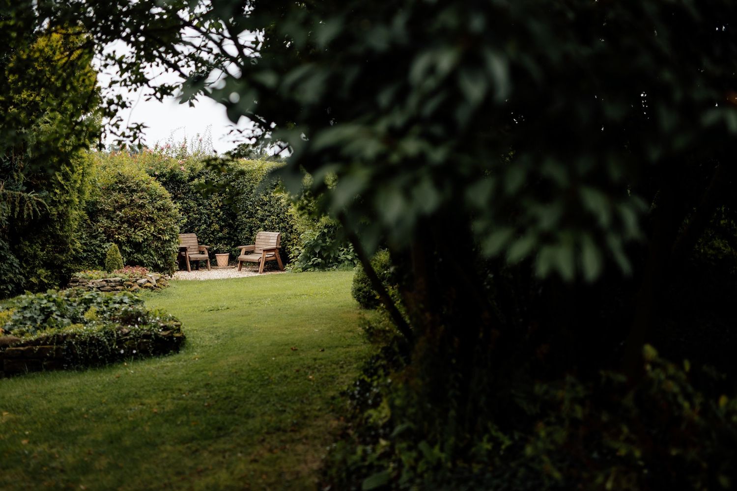 Serene garden venue with manicured lawn and landscaping for outdoor wedding.