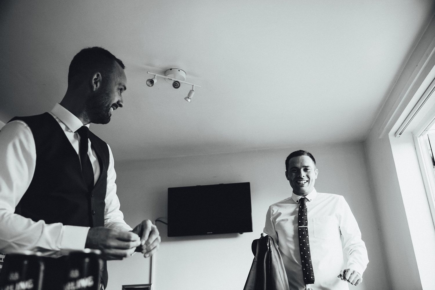 Black and white photo of wedding preparations in an elegant room.