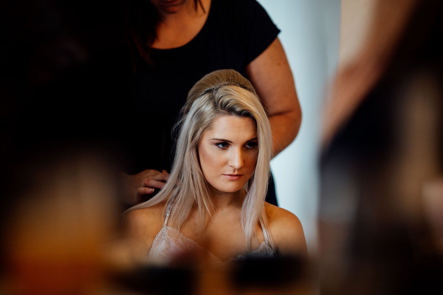 Wedding preparation moments captured in intimate lighting.