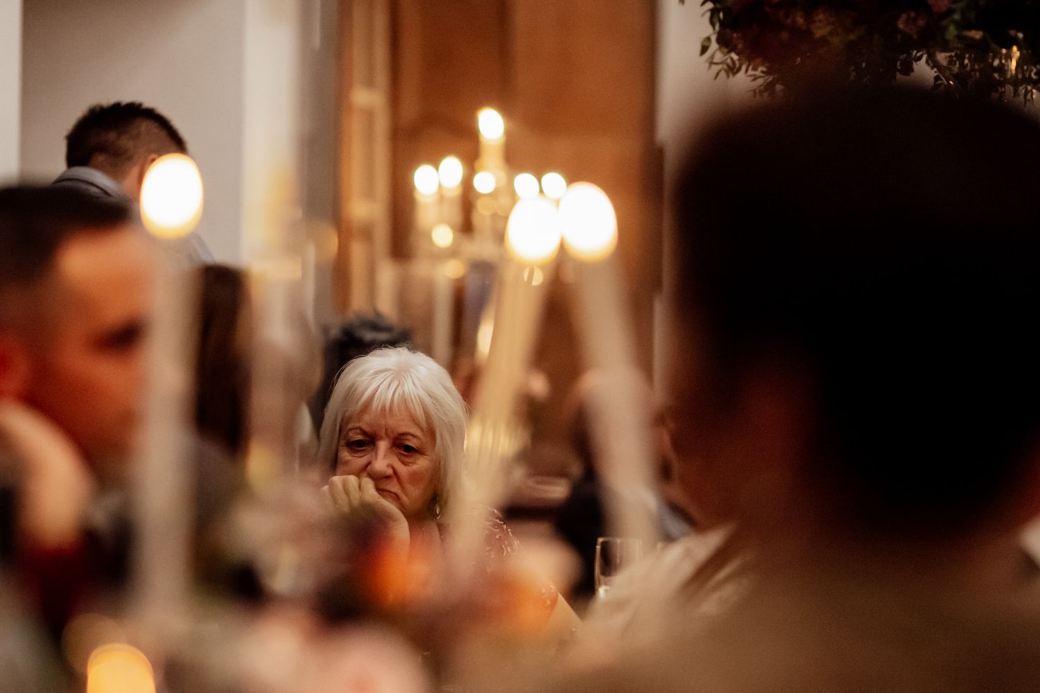 Warm candlelit ambiance at an elegant wedding reception venue.