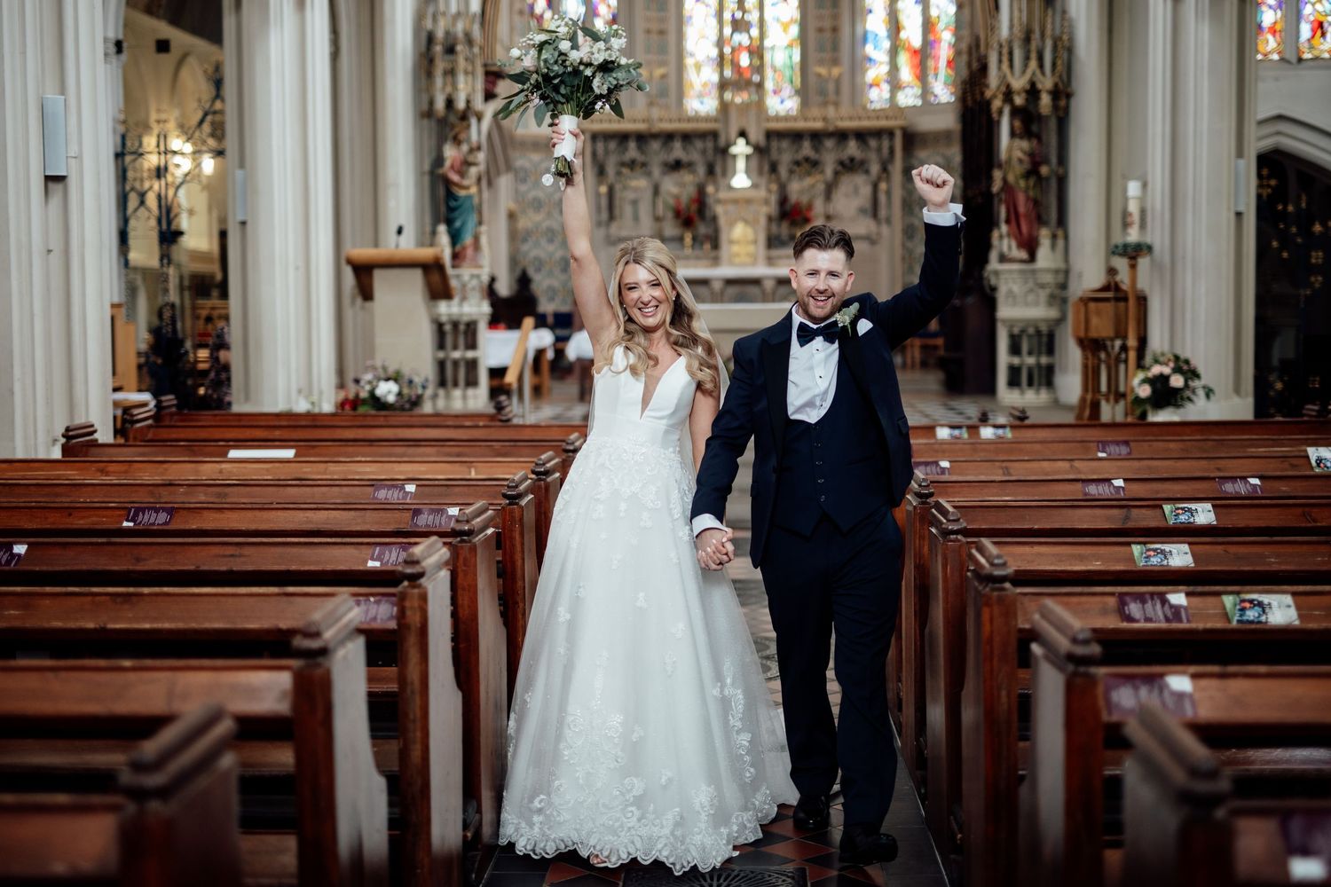 Traditional church wedding ceremony in a grand cathedral with ornate architecture.