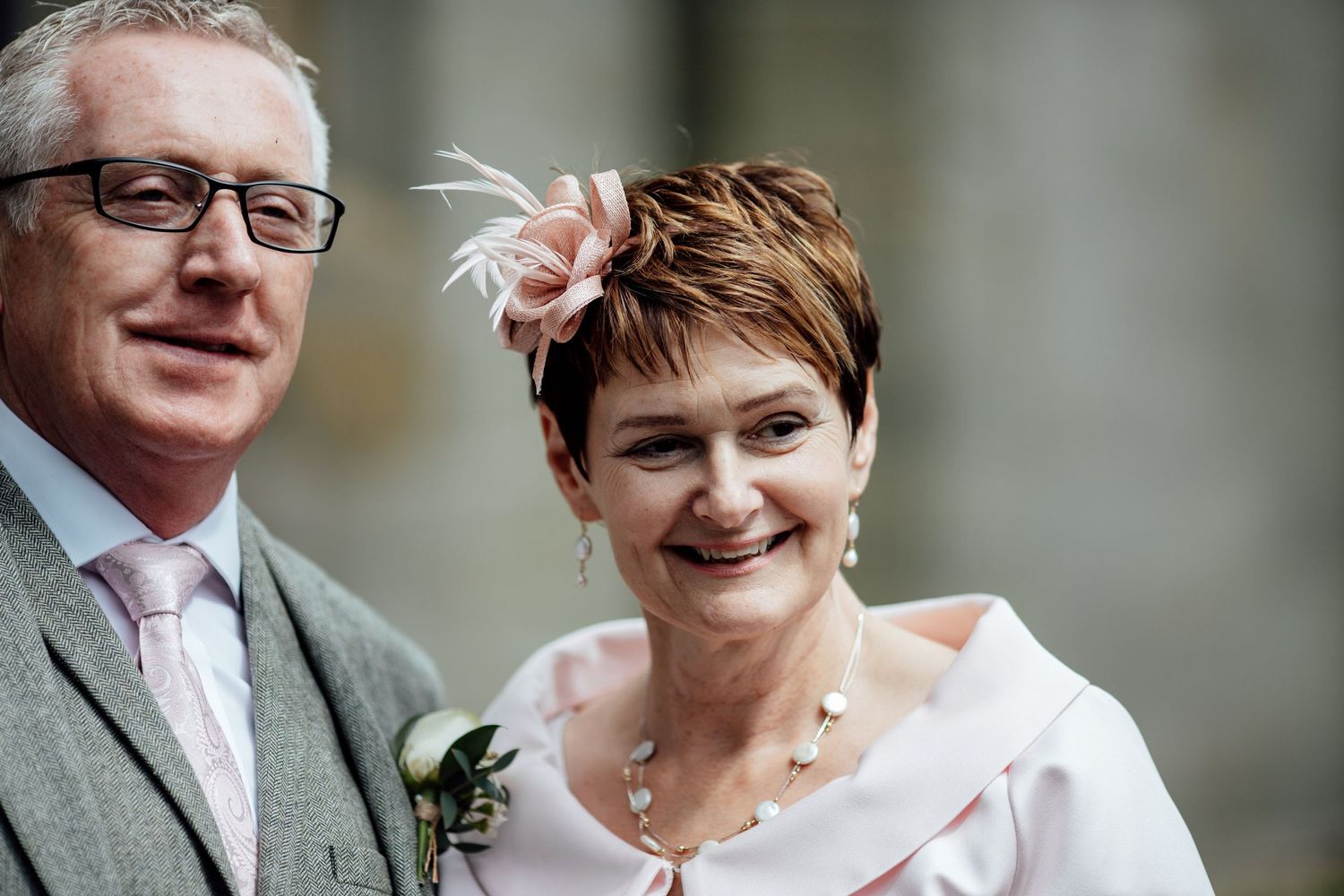 A wedding couple sharing a joyful moment together outdoors.