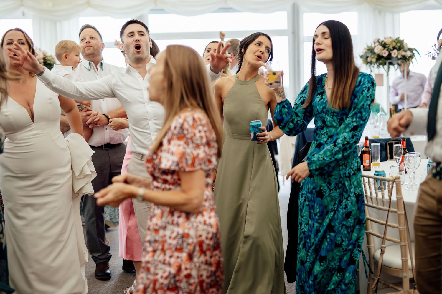 Guests enjoying themselves during a lively wedding reception celebration.