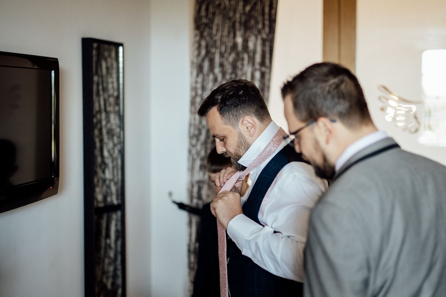 Wedding preparation moments captured in an elegant indoor setting with natural light.