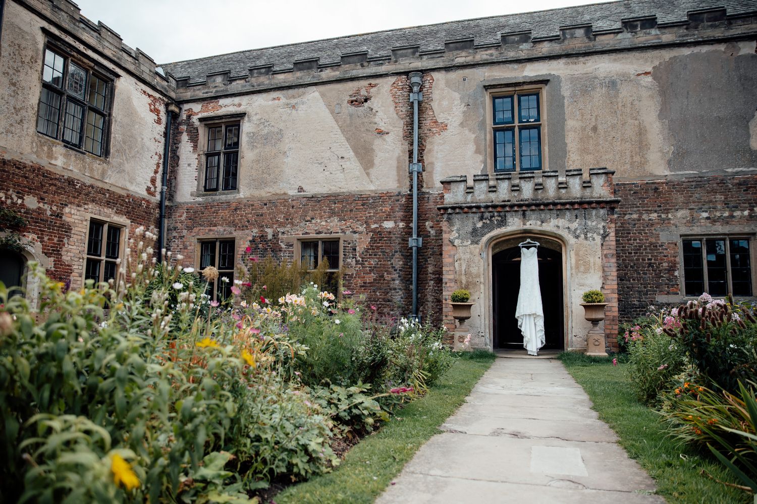 Historic stone building exterior with arched walkways and weathered walls.