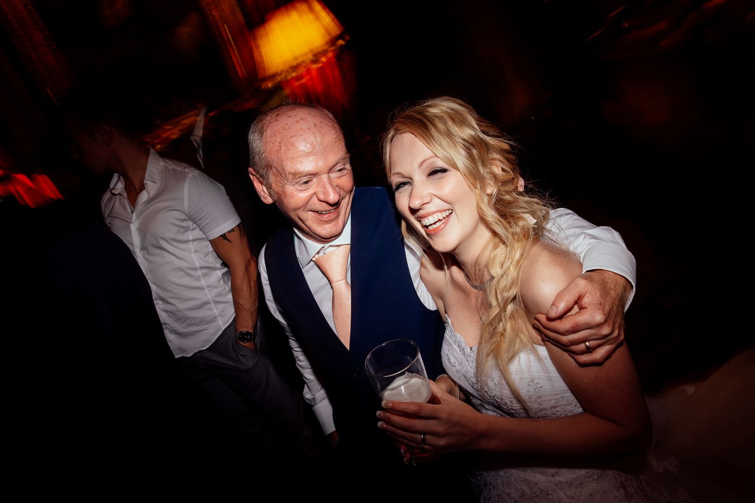 Dance floor moments captured in warm lighting at wedding reception.