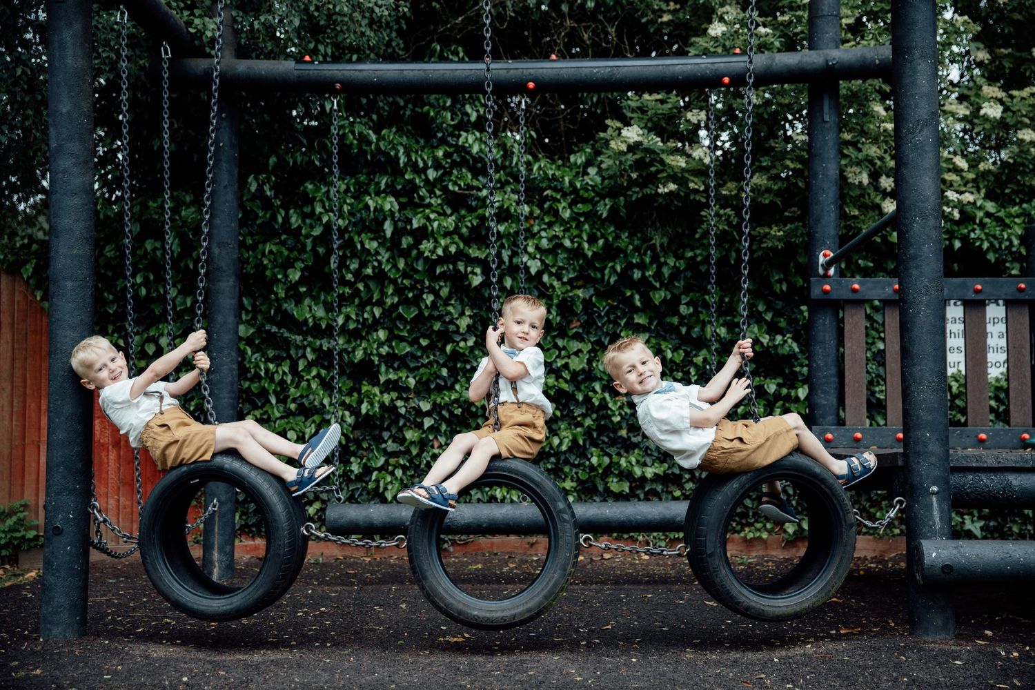 Creative wedding photo composition featuring tire swings in a garden setting.