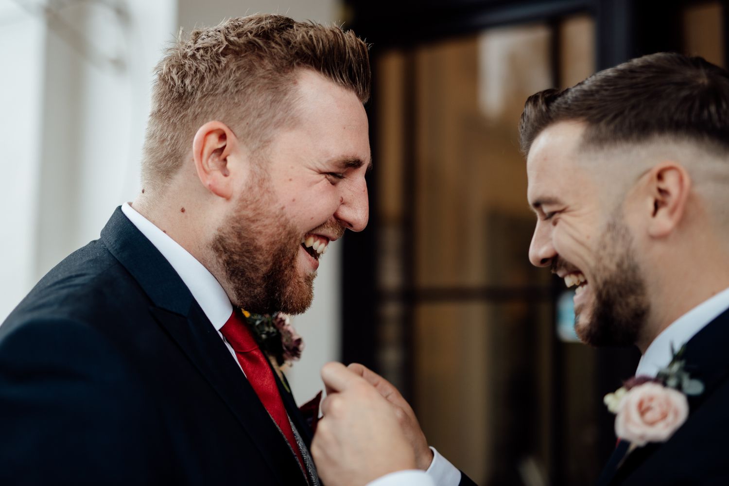 Two people share a joyful moment during a formal event.