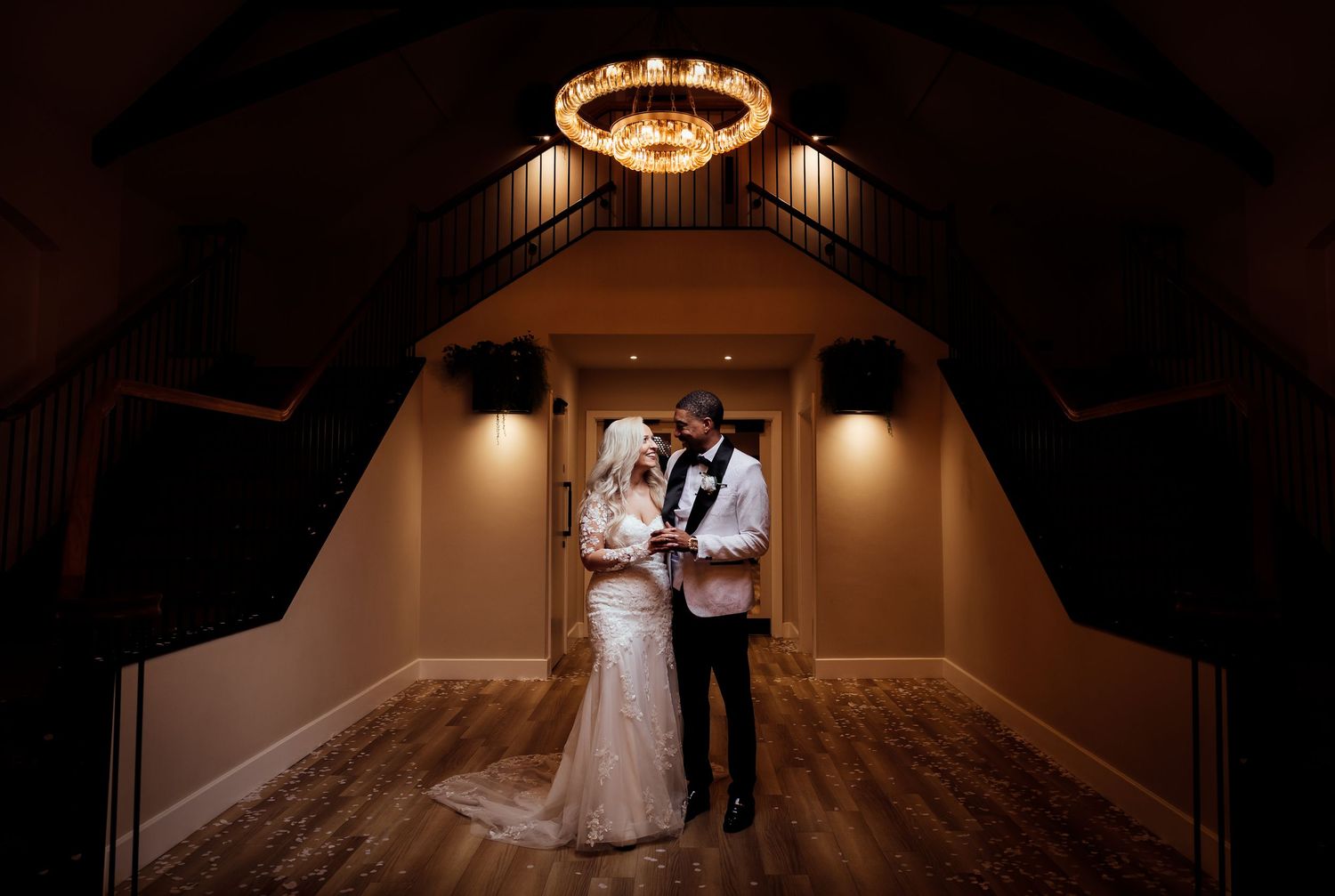 A couple dances in a warmly lit ballroom during their wedding celebration. Whistle Barn Wedding Photography