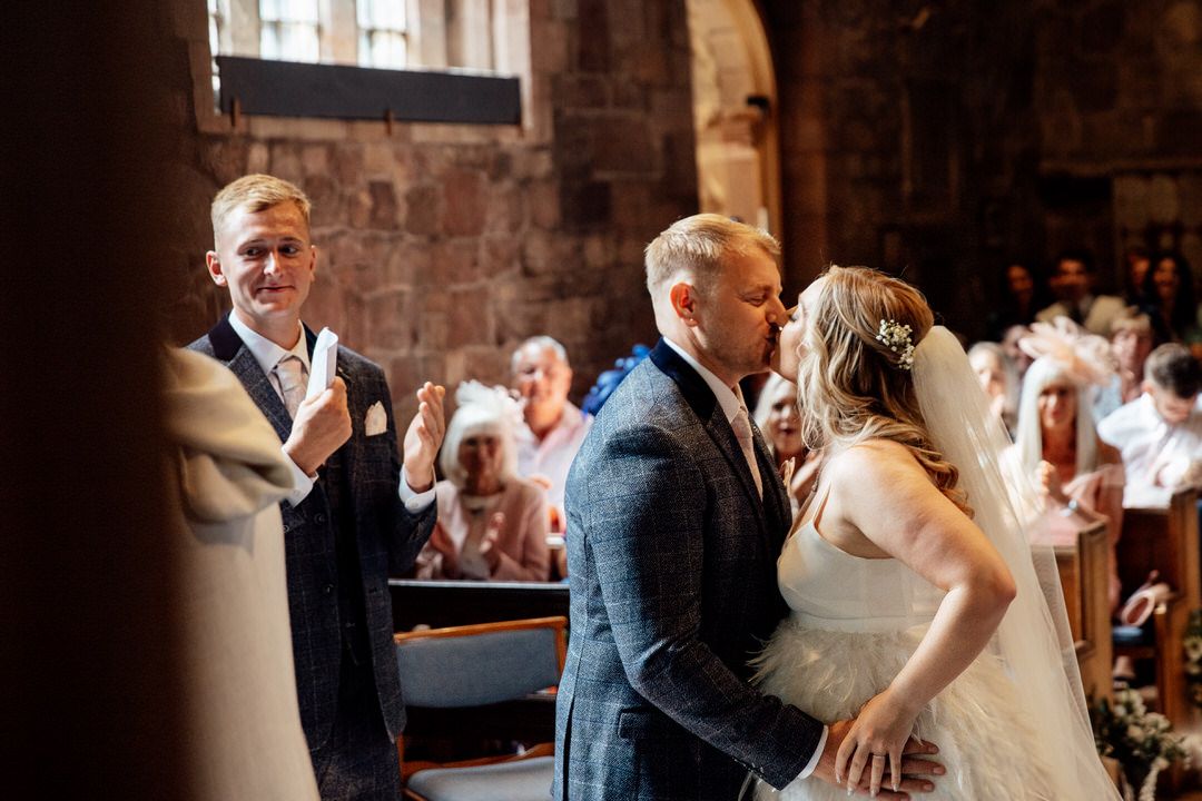 Wedding celebration candid moments captured in a historic brick venue.