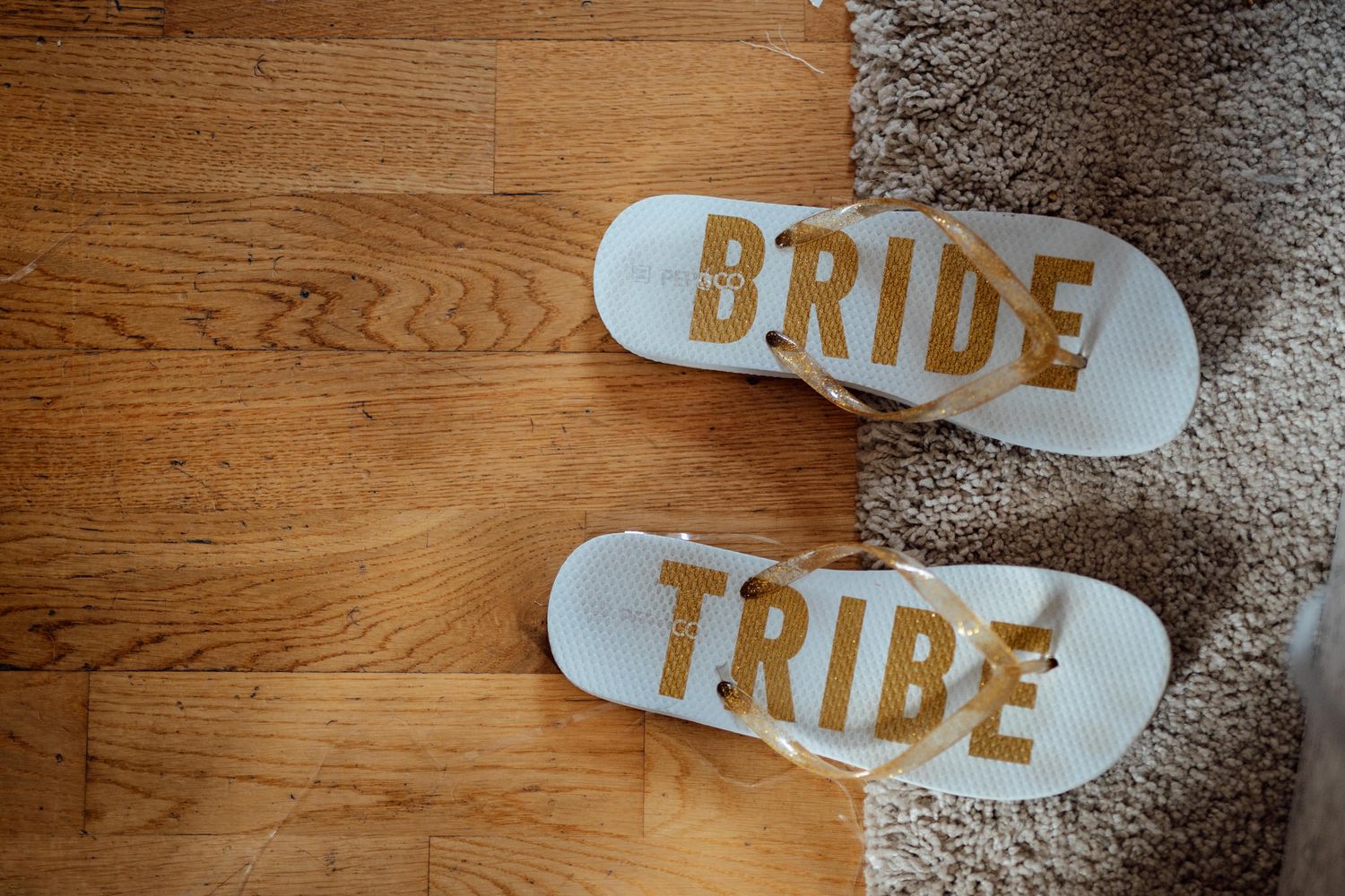 Wooden wedding decor signs reading 'Bride Tribe' arranged on a rustic wooden surface.