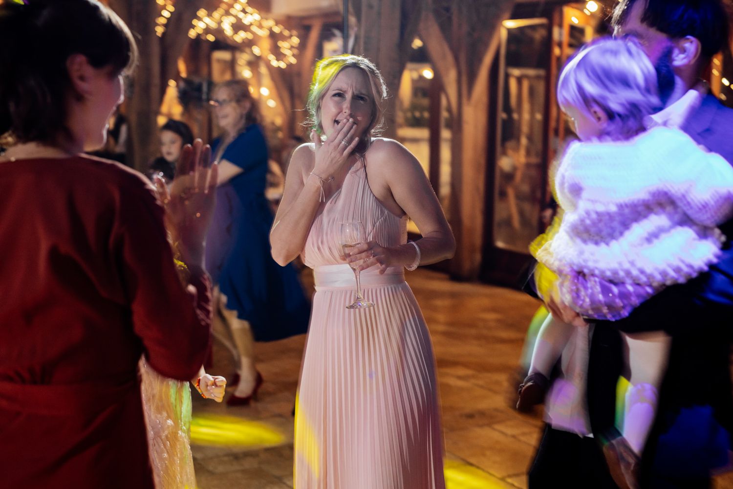 Wedding reception dance floor with purple lighting and festive atmosphere.