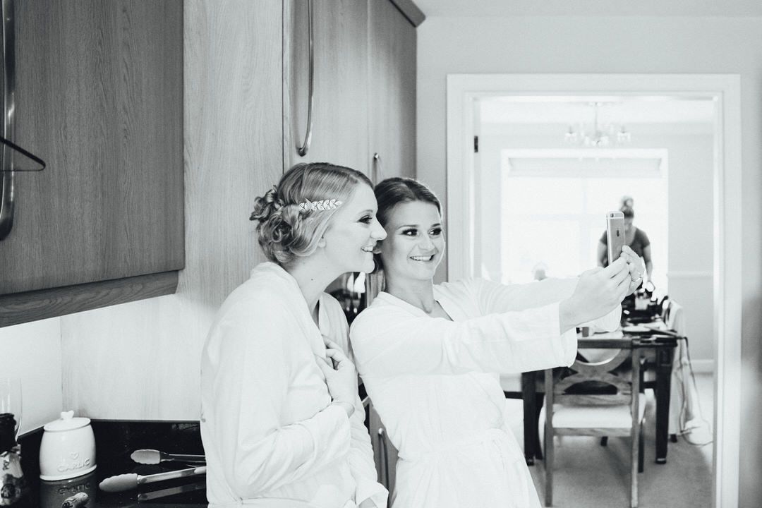 Black and white photos showing wedding preparation moments in a bright interior space.