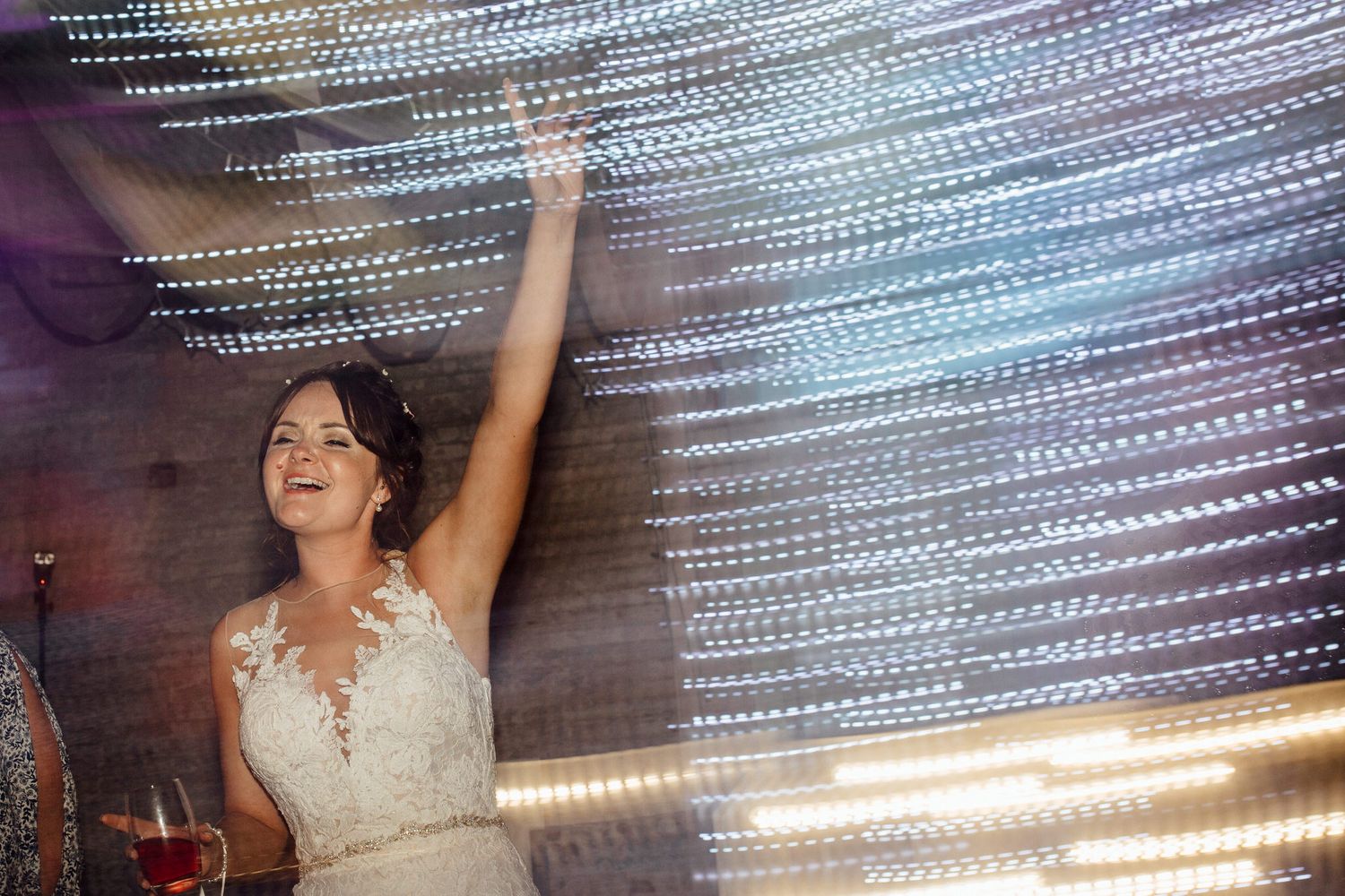 Sparkling lights create a magical atmosphere at an evening wedding reception.