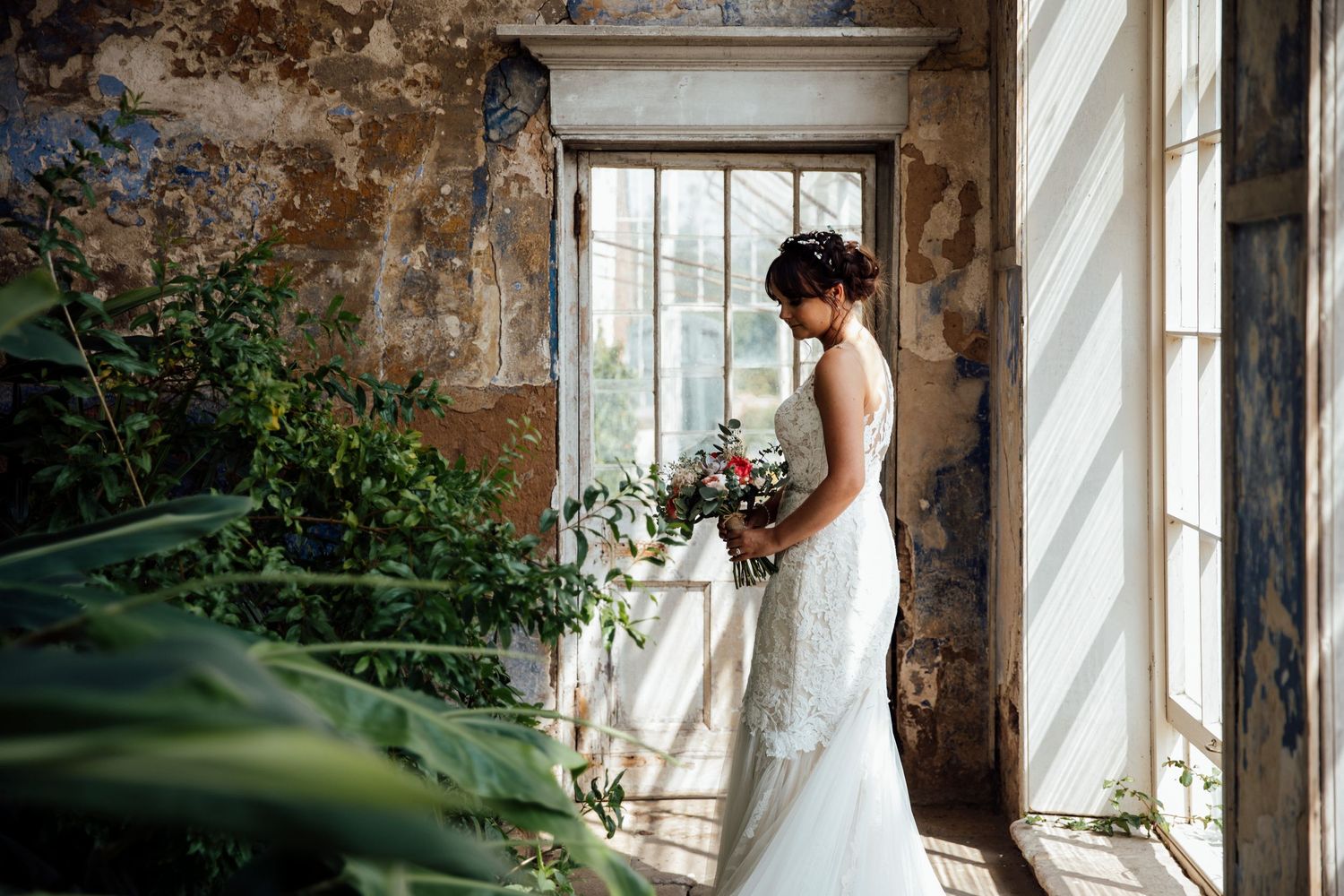 Elegant wedding venue interior with exposed brick walls and large windows.
