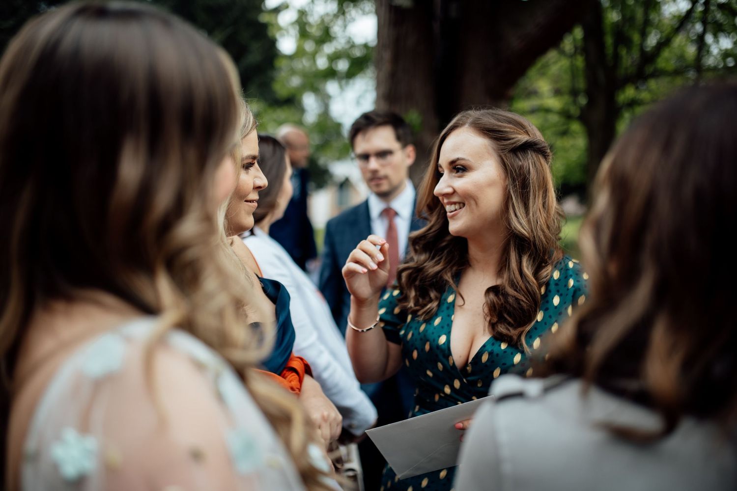 Guests enjoying outdoor cocktail hour at a rustic wedding venue.